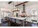 Open concept kitchen with large island, stainless steel appliances, and breakfast bar overlooking the dining area at 8310 Raphael Ln, Littleton, CO 80125