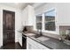 Contemporary kitchen boasts sleek countertops, stainless steel sink, stylish backsplash, and natural lighting at 8310 Raphael Ln, Littleton, CO 80125