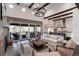 Inviting living room with fireplace, expansive windows to outside patio, and open layout to the modern kitchen at 8310 Raphael Ln, Littleton, CO 80125