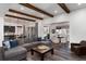 Open-concept living room flowing into dining area, featuring hardwood floors and ample seating at 8310 Raphael Ln, Littleton, CO 80125