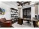 Handsome home office with a beamed ceiling, custom shelving, and a comfortable workspace at 8310 Raphael Ln, Littleton, CO 80125
