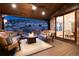 Inviting covered patio with comfortable seating and a cozy fire pit overlooking scenic views at 8310 Raphael Ln, Littleton, CO 80125