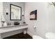 Elegant powder room with stylish wallpaper, modern vanity, and sophisticated decor at 8310 Raphael Ln, Littleton, CO 80125
