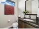 Stylish powder room with granite vanity, decorative mirror, and contemporary design elements at 1882 W 67Th Ave, Denver, CO 80221