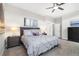 Bedroom featuring carpet floors, a modern ceiling fan, multiple windows and stylish bedside lighting at 1882 W 67Th Ave, Denver, CO 80221