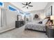 Bedroom featuring a modern ceiling fan, multiple windows and a stylish dresser and decor at 1882 W 67Th Ave, Denver, CO 80221