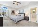 Bedroom featuring carpet floors, a modern ceiling fan, multiple windows and a stylish dresser and decor at 1882 W 67Th Ave, Denver, CO 80221