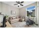 Comfortable and cozy bedroom with a ceiling fan, a couch, and a bright window at 1882 W 67Th Ave, Denver, CO 80221