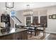 Charming dining room with ample natural light, a modern chandelier, and a view of the staircase at 1882 W 67Th Ave, Denver, CO 80221