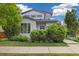 Charming two-story home with mature landscaping, manicured lawn, and inviting curb appeal at 1882 W 67Th Ave, Denver, CO 80221