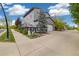 Home exterior with a two car garage and landscaped front yard on a sunny day at 1882 W 67Th Ave, Denver, CO 80221