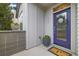 Inviting front entrance features a vibrant purple door, decorative wreath, and potted floral arrangements at 1882 W 67Th Ave, Denver, CO 80221