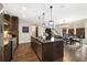 Open kitchen featuring a large island, stainless steel appliances, and adjacent dining area at 1882 W 67Th Ave, Denver, CO 80221