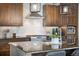 Kitchen with wooden cabinets, stainless steel range hood, tile backsplash, and gas stove at 1882 W 67Th Ave, Denver, CO 80221