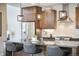 Close-up of the kitchen island featuring pendant lighting, stainless steel appliances and granite countertops at 1882 W 67Th Ave, Denver, CO 80221