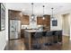Stylish kitchen with dark wood cabinetry, stainless steel appliances, and a center island with bar seating at 1882 W 67Th Ave, Denver, CO 80221
