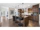 Spacious kitchen with an island and bar seating; adjacent to a living area at 1882 W 67Th Ave, Denver, CO 80221