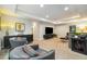 Bright living room featuring a large entertainment system, sofa, and 2 armchairs at 1882 W 67Th Ave, Denver, CO 80221
