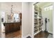 Walk-in pantry with white shelving and wicker baskets providing ample storage space, kitchen view at 1882 W 67Th Ave, Denver, CO 80221