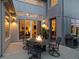 Cozy outdoor patio with a fire pit and dining set, accessible through sliding glass doors at 1882 W 67Th Ave, Denver, CO 80221