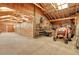 Spacious barn with multiple stalls and tractor parking, perfect for equestrian enthusiasts or farm operations at 26526 Gray Buck Trl, Conifer, CO 80433