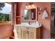 Charming bathroom with light wood vanity, modern fixtures, and ample natural light at 26526 Gray Buck Trl, Conifer, CO 80433