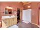 This bathroom features a spacious vanity, a walk-in shower, and a closet for ample storage at 26526 Gray Buck Trl, Conifer, CO 80433