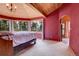 A bedroom with vaulted wood ceilings and large windows for natural light and views at 26526 Gray Buck Trl, Conifer, CO 80433