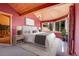 Inviting bedroom with a large bed, natural light, and wood-paneled ceiling at 26526 Gray Buck Trl, Conifer, CO 80433