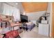 This bedroom features a slanted wooden ceiling with a bed and a desk in the room at 26526 Gray Buck Trl, Conifer, CO 80433
