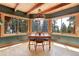 Dining room with views from the windows, light wood floor and unique lighting fixture at 26526 Gray Buck Trl, Conifer, CO 80433