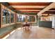 Dining area with natural light, wooden table, and a view of the serene outdoors at 26526 Gray Buck Trl, Conifer, CO 80433