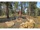 Outdoor stone fire pit with seating area, perfect for entertaining and enjoying cozy evenings at 26526 Gray Buck Trl, Conifer, CO 80433