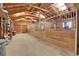 Spacious horse barn featuring multiple stalls with wood partitions at 26526 Gray Buck Trl, Conifer, CO 80433