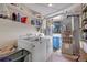 Functional laundry room with washer, dryer, shelving, and utilities at 26526 Gray Buck Trl, Conifer, CO 80433