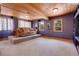 Carpeted living room featuring a raised platform and view to the outside at 26526 Gray Buck Trl, Conifer, CO 80433