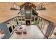 This is a bright living room with wood floors, a vaulted ceiling, and a wood burning stove at 26526 Gray Buck Trl, Conifer, CO 80433