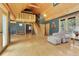 Spacious living area with vaulted ceilings, hardwood floors, and access to a lofted space at 26526 Gray Buck Trl, Conifer, CO 80433