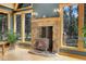 Inviting living room with a stone fireplace, wood floors, and bright windows offering serene views at 26526 Gray Buck Trl, Conifer, CO 80433