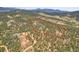 Aerial view of land lot surrounded by trees; the property line is outlined in red at 26526 Gray Buck Trl, Conifer, CO 80433