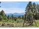 Relaxing swing set overlooking a mountain view, providing a peaceful outdoor retreat at 26526 Gray Buck Trl, Conifer, CO 80433