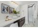 Bathroom featuring a spacious vanity, updated fixtures, and a shower/tub combo at 9725 E Harvard Ave # 323, Denver, CO 80231