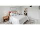 A well-appointed bedroom with neutral tones, an adjacent bathroom, and stylish furnishings at 9725 E Harvard Ave # 323, Denver, CO 80231