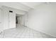 Unfurnished bedroom featuring a large window and white tile flooring at 9725 E Harvard Ave # 323, Denver, CO 80231