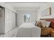 Bright bedroom with a large window, white walls, and a spacious closet for ample storage at 9725 E Harvard Ave # 323, Denver, CO 80231