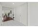 Bright hallway features tile flooring, neutral walls, and a peek into a dining area, creating an inviting entrance at 9725 E Harvard Ave # 323, Denver, CO 80231