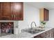 Kitchen features stainless steel sink, stylish countertops, and dark wood cabinetry at 9725 E Harvard Ave # 323, Denver, CO 80231
