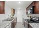 Well-lit kitchen with stainless steel appliances, granite countertops, and classic cabinetry at 9725 E Harvard Ave # 323, Denver, CO 80231