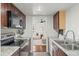 Well-lit kitchen featuring granite countertops, stainless steel appliances, and an open view to the living room at 9725 E Harvard Ave # 323, Denver, CO 80231