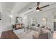 Bright living room featuring a modern sofa, accent chairs, ceiling fan, and stylish decor at 9725 E Harvard Ave # 323, Denver, CO 80231